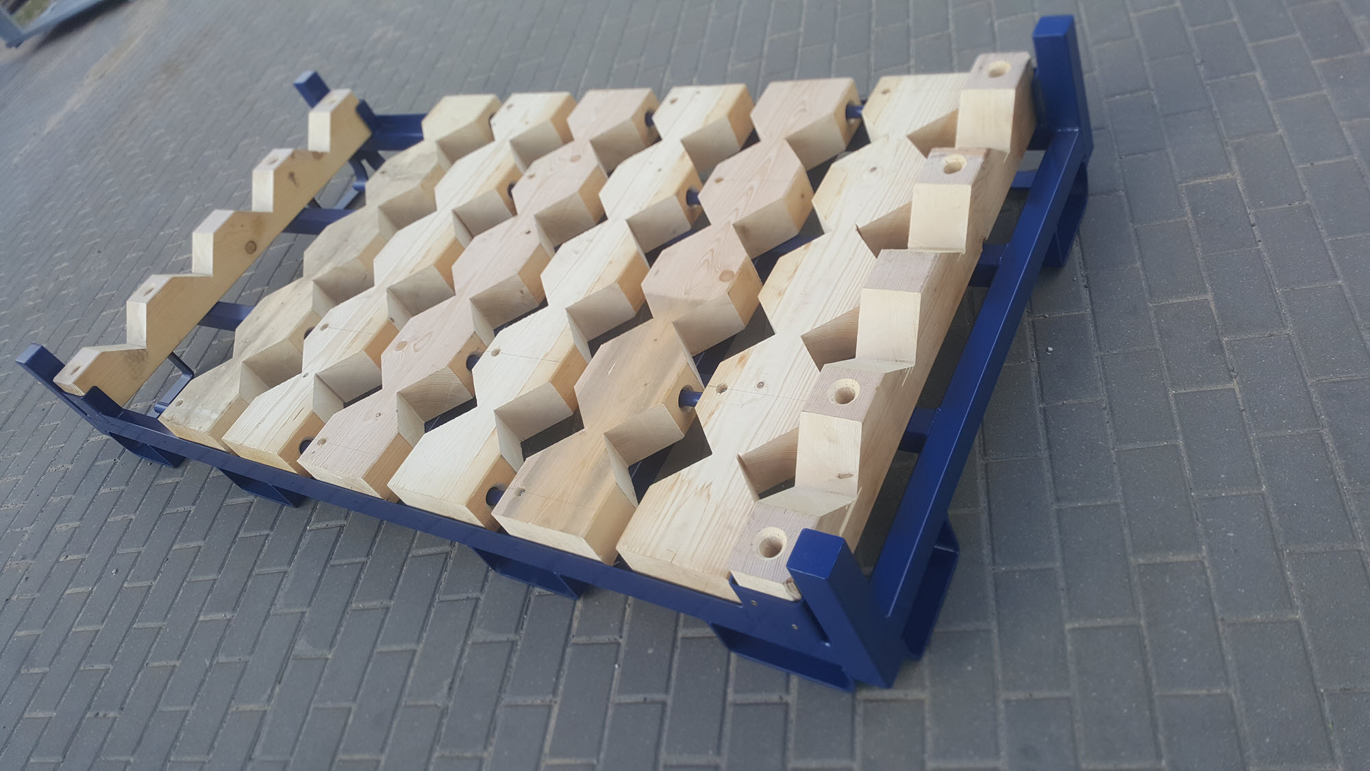 Rollenpalette mit steckbaren Holzprismen für Lagerung und Transport von Rollen