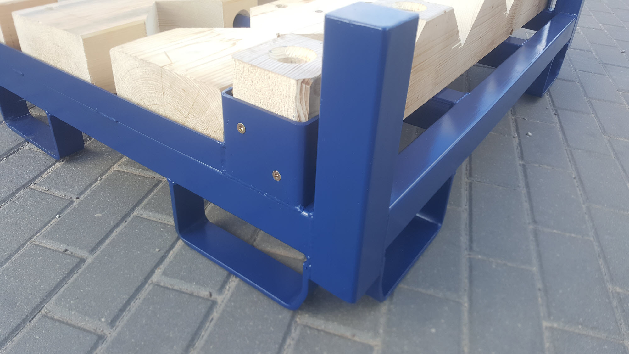 Detailansicht Holzprisma in Halterung auf der Palette sowie Abrutschsicherung für Gabelzinken