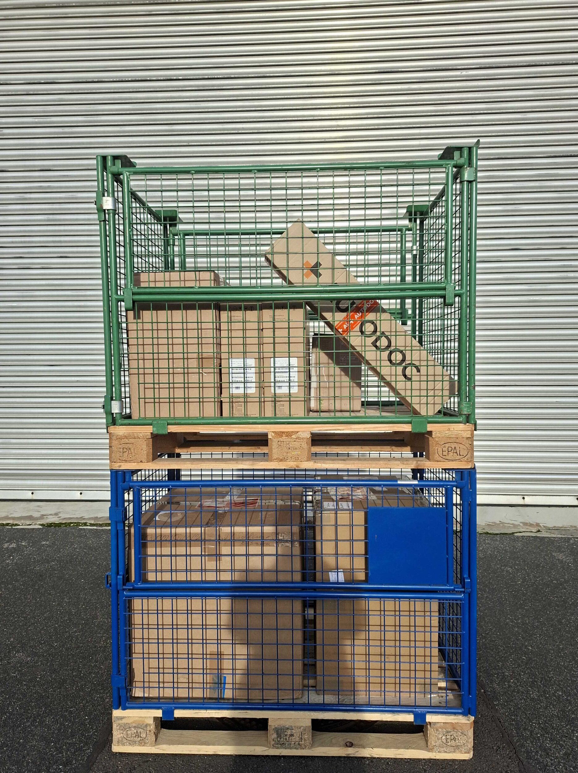 Gitterboxen auf Europaletten mit Kartonverpackungen vor Lagerhalle